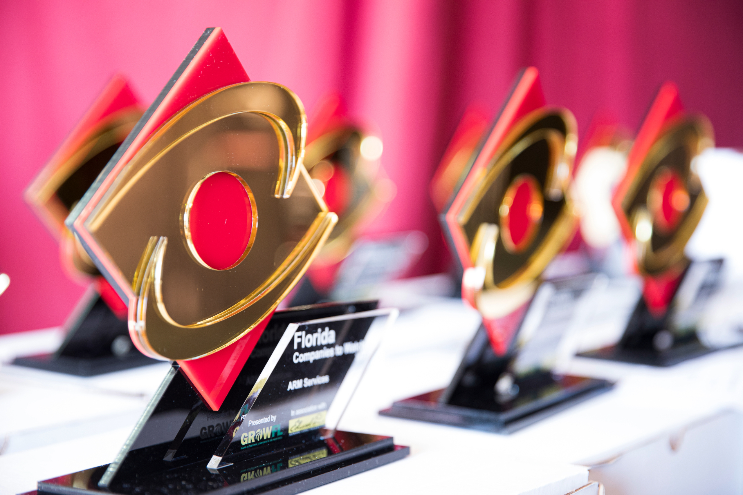 a row of gold awards on a table